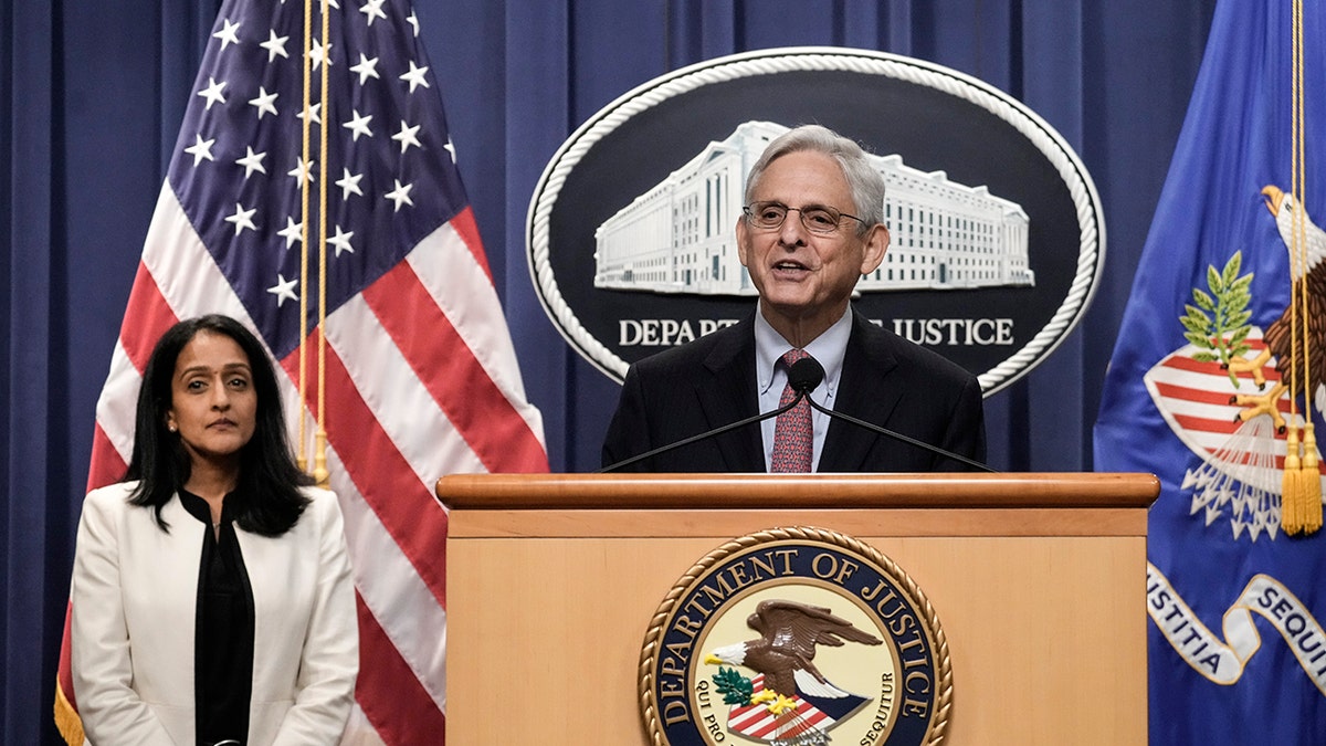 AG Merrick Garland at podium with Associate Attorney General Vanita Gupta