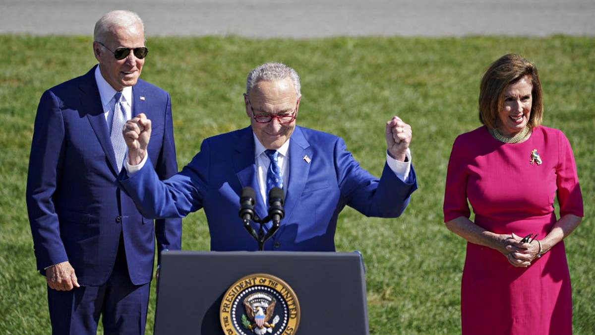 Chuck Schumer, Nancy Pelosi and Joe Biden at a signing ceremony