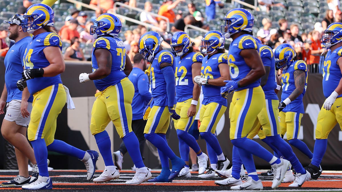 The Rams run off the field during a preseason game