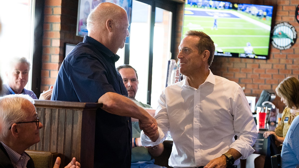 budd shakes hands with supporter