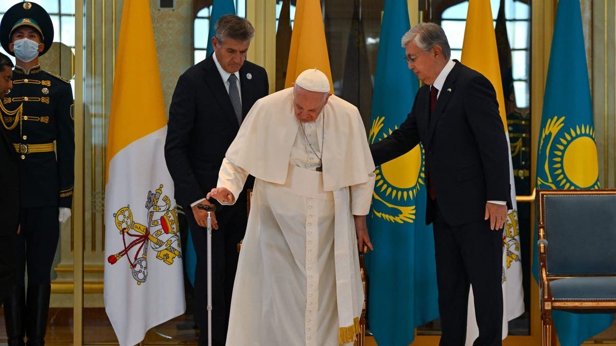 Pope Francis walks with Kazakh President Kassym-Jomart Tokayev