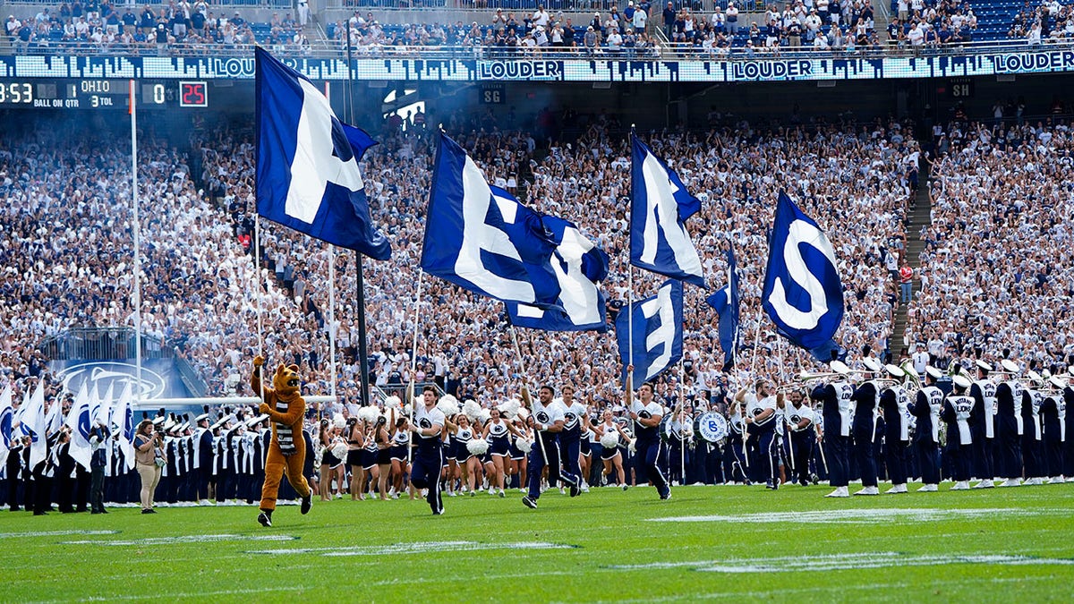 Penn State Nittany Lion Mascot runs onto the field 