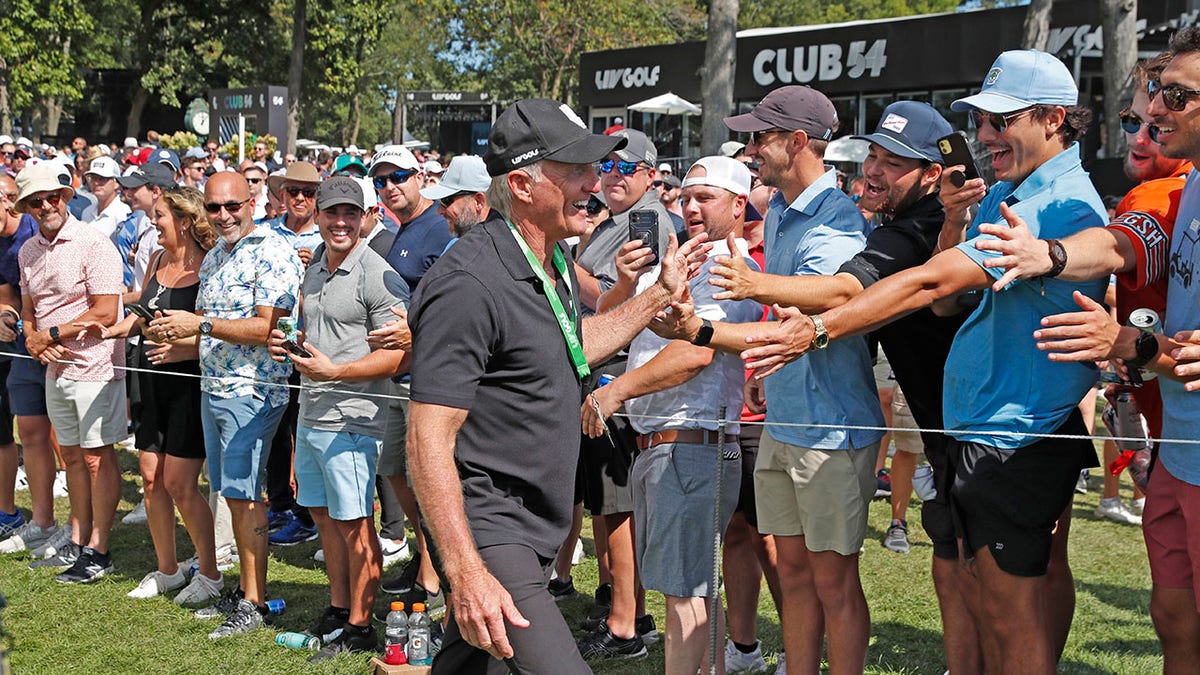 Greg Norman high fives fans