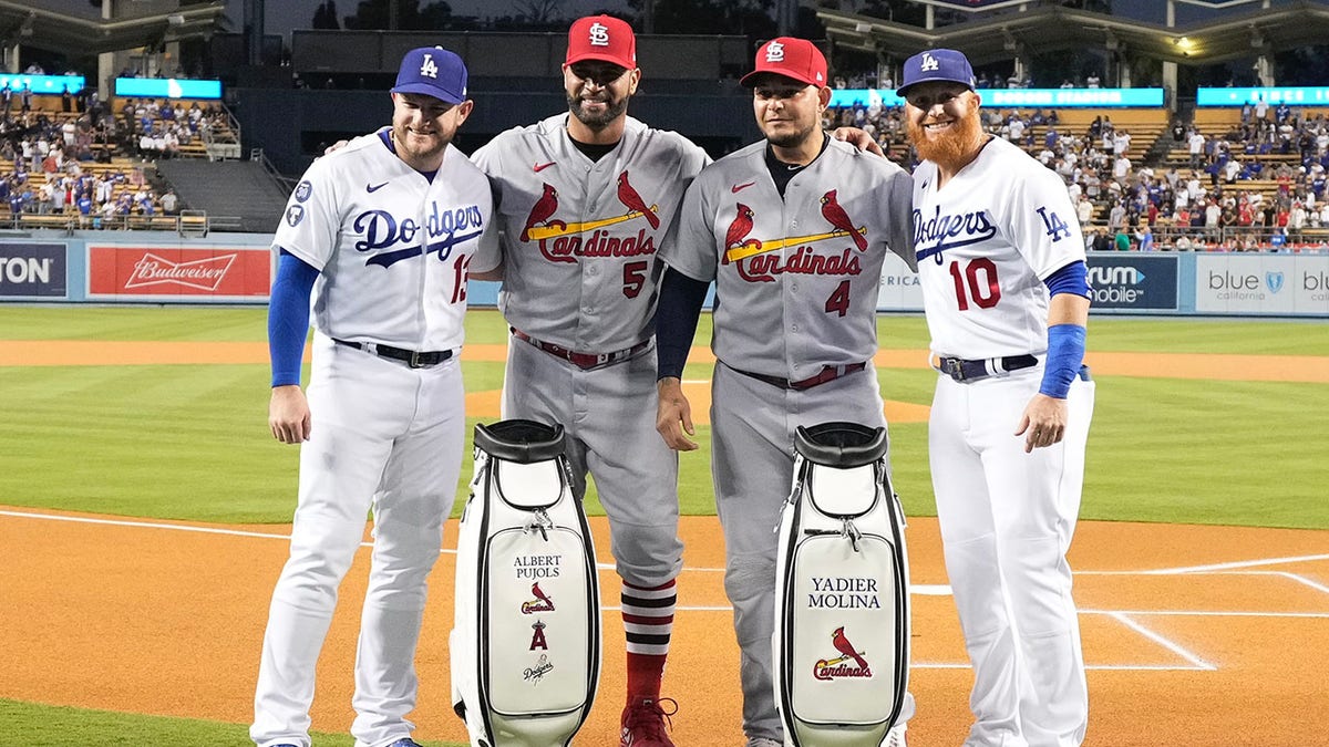 Albert Pujols and Yadier Molina pose for a picture with two Dodgers players