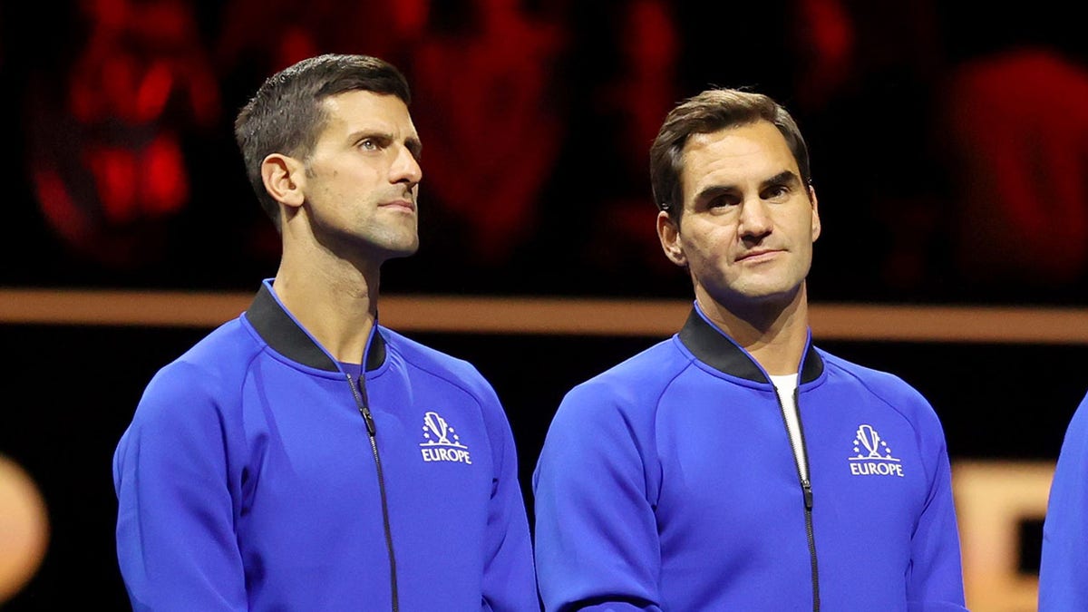 Novak Djokovic stands with Roger Federer at Laver Cup