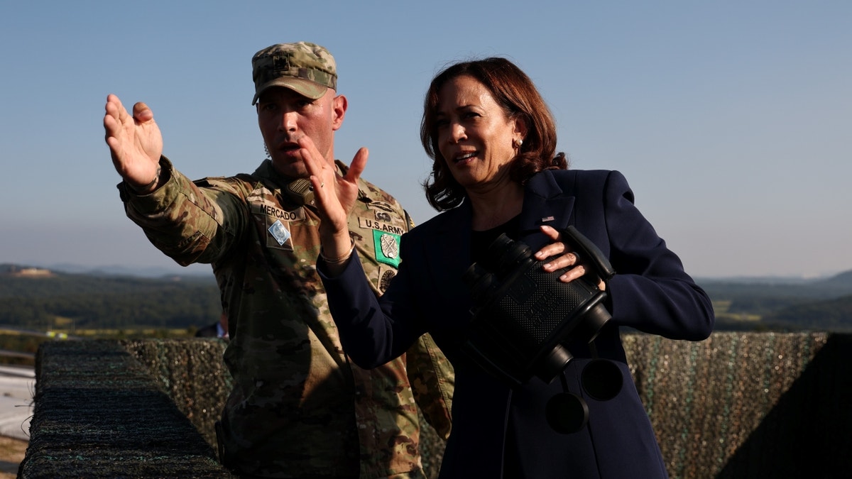 Harris holding binoculars at DMZ