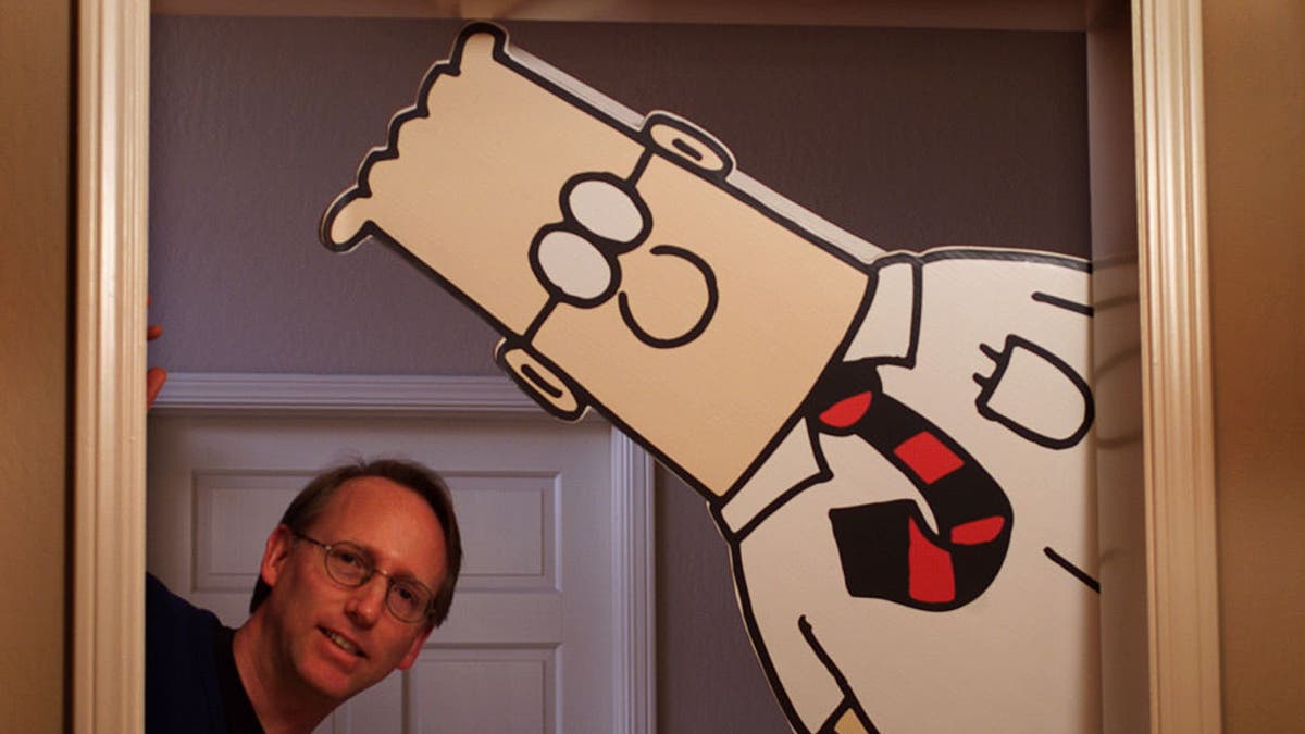 Scott Adams standing next to Dilbert cutout