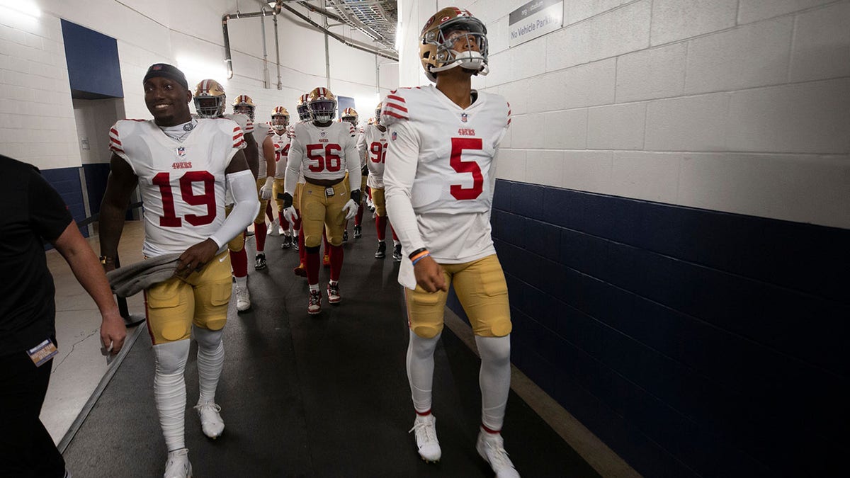 Trey Lance and Deebo Samuel before a preseason game