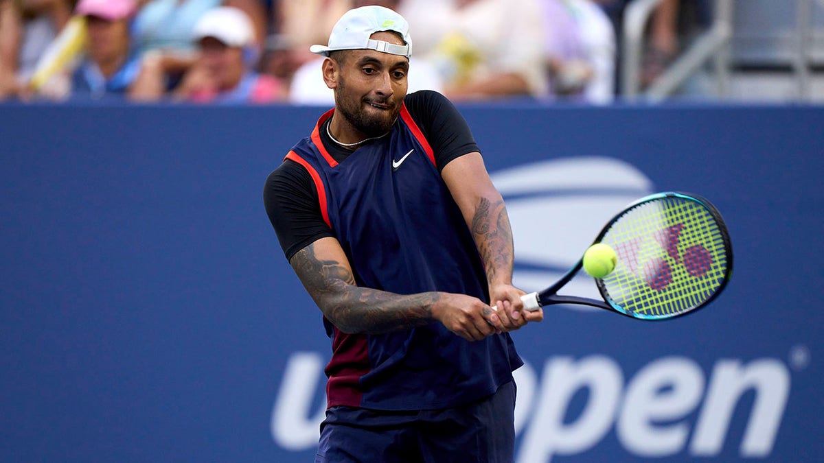 Nick Kyrgios returns a ball at the 2022 US Open