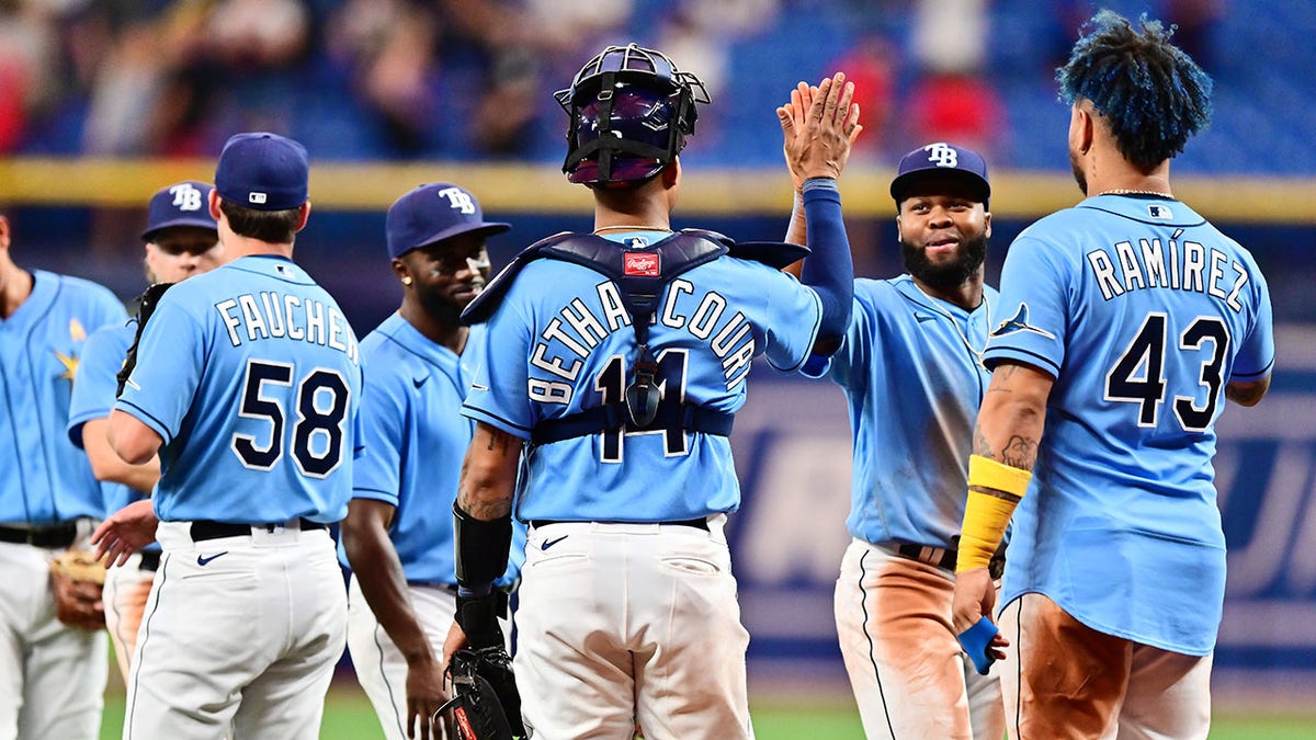 The Tampa Bay Rays celebrate after beating the Yankees