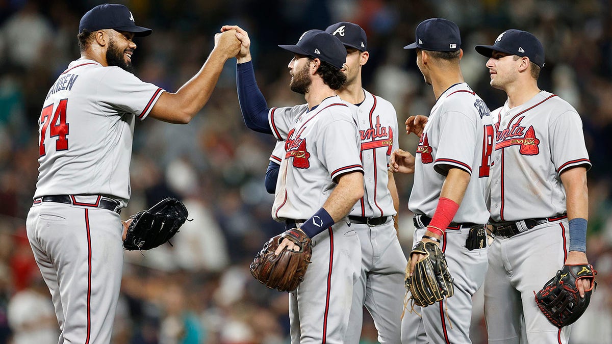 The Braves celebrate after beating the Mariners