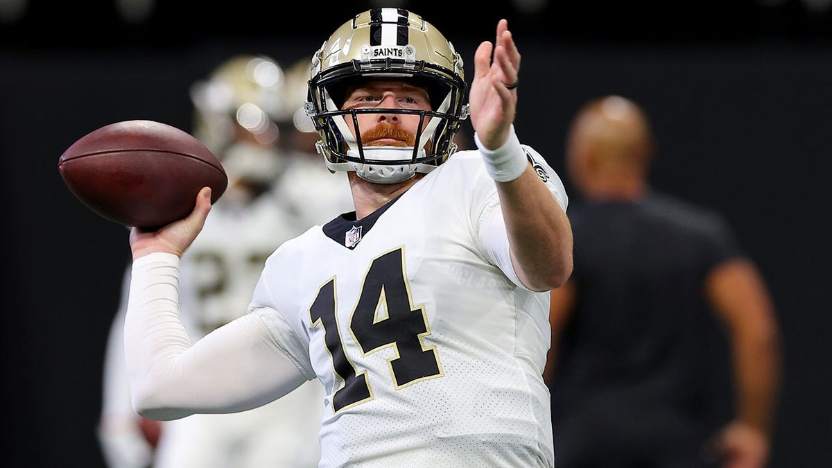 Andy Dalton warms up before playing the Falcons