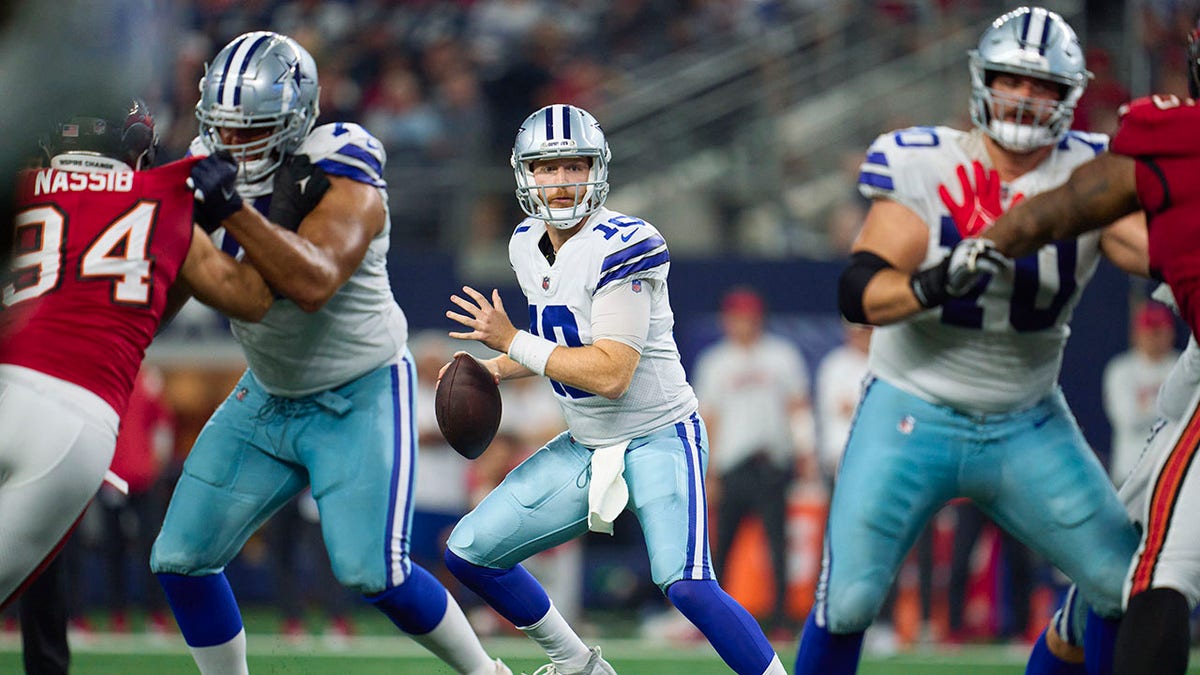 Cooper Rush drops back to pass