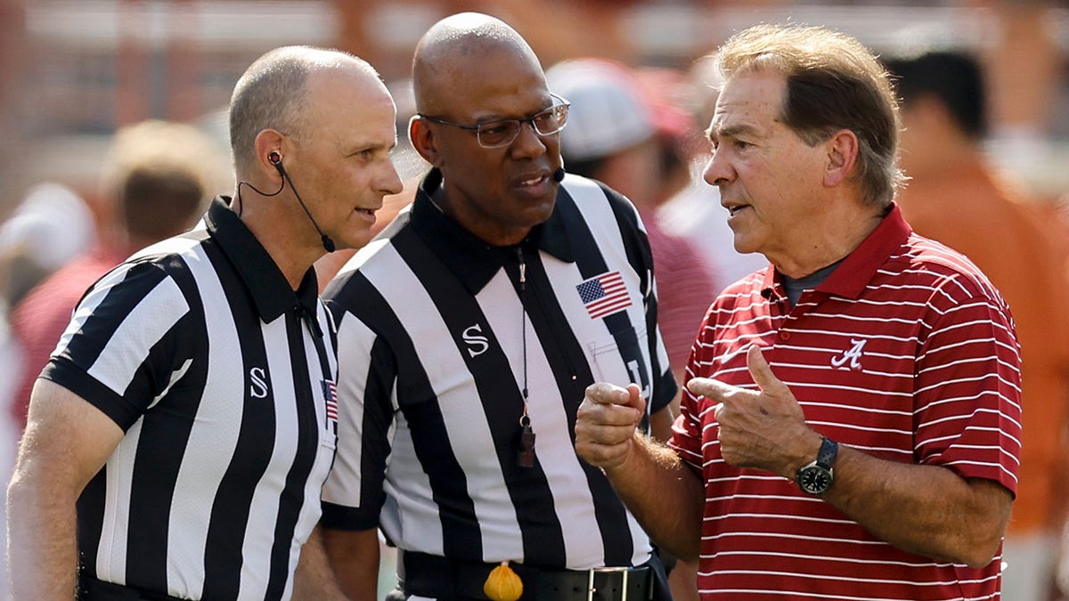 Head coach Nick Saban talks to officials during the Texas game