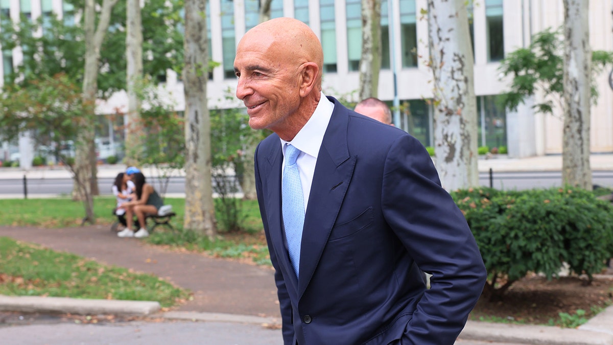 Tom Barrack smiles outside Brooklyn court