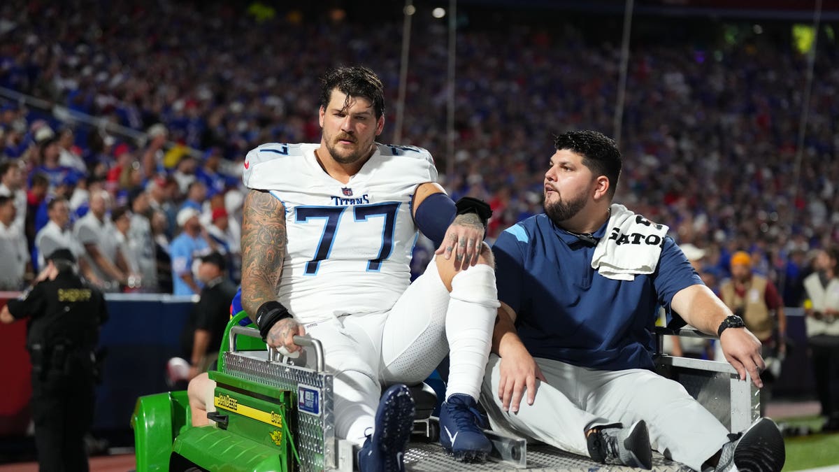 Titans Taylor Lewan is carted off the field