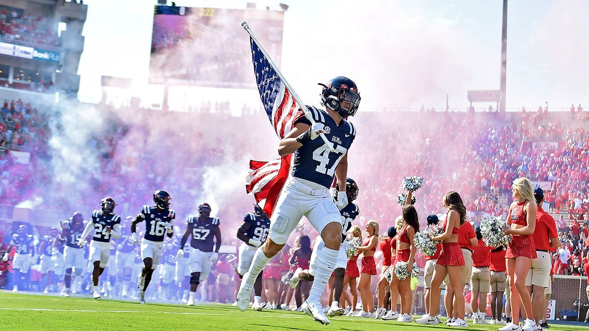 An Ole Miss player runs out onto the field