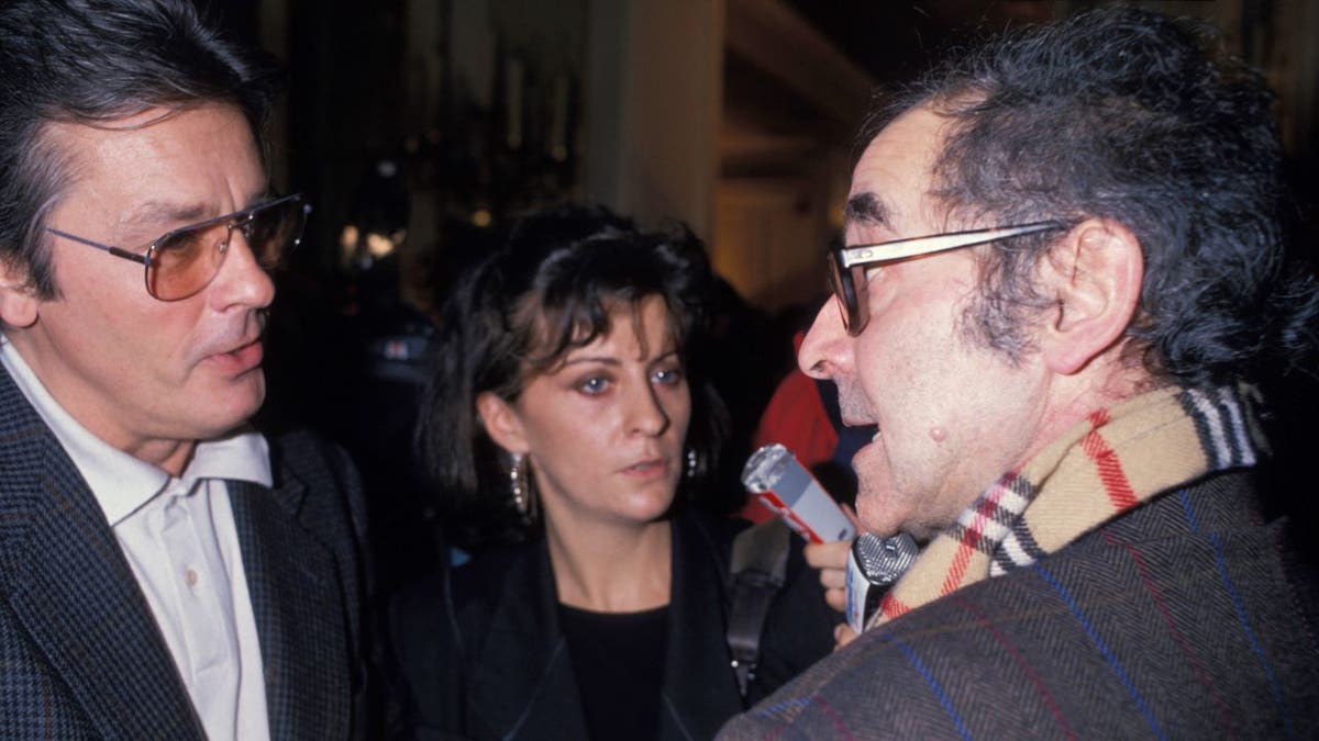 Alain Delon and Jean-Luc Godard talking