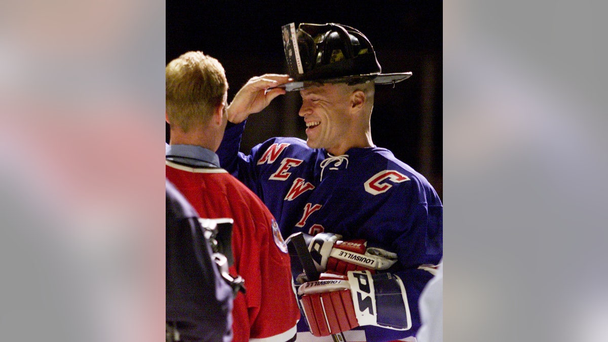 NHL hall of famer Mark Messier wearing the FDNY helmet of fallen FDNY Chief Ray Downey