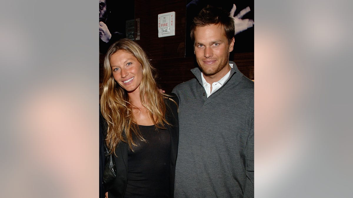 Gisele Bundchen smiles next to Tom Brady in a older photo of the couple