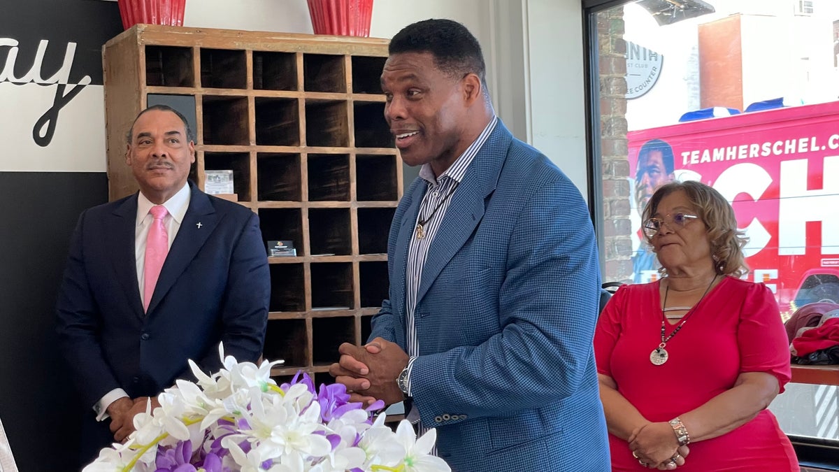 Herschel Walker smiling while at an event before the midterms