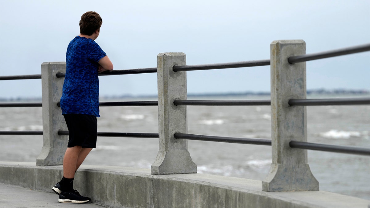 Boy looking out towards the water