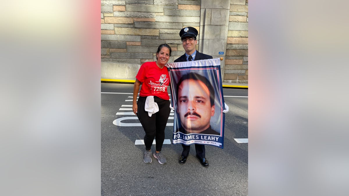 Marcela Leahy and her son holding a picture of James Leahy