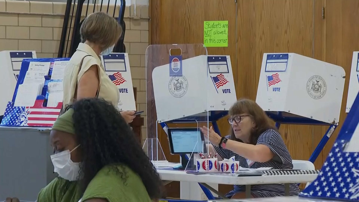 A women checks in to vote at a busy polling location