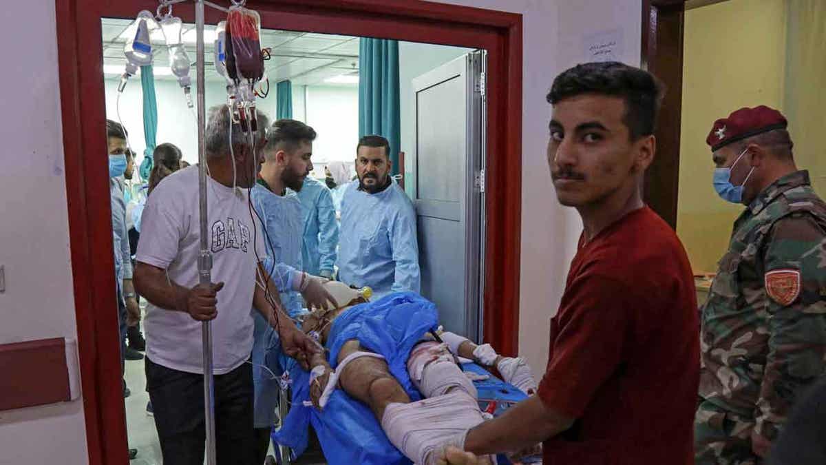 A wounded man receives treatment at a hospital following strikes by Iran