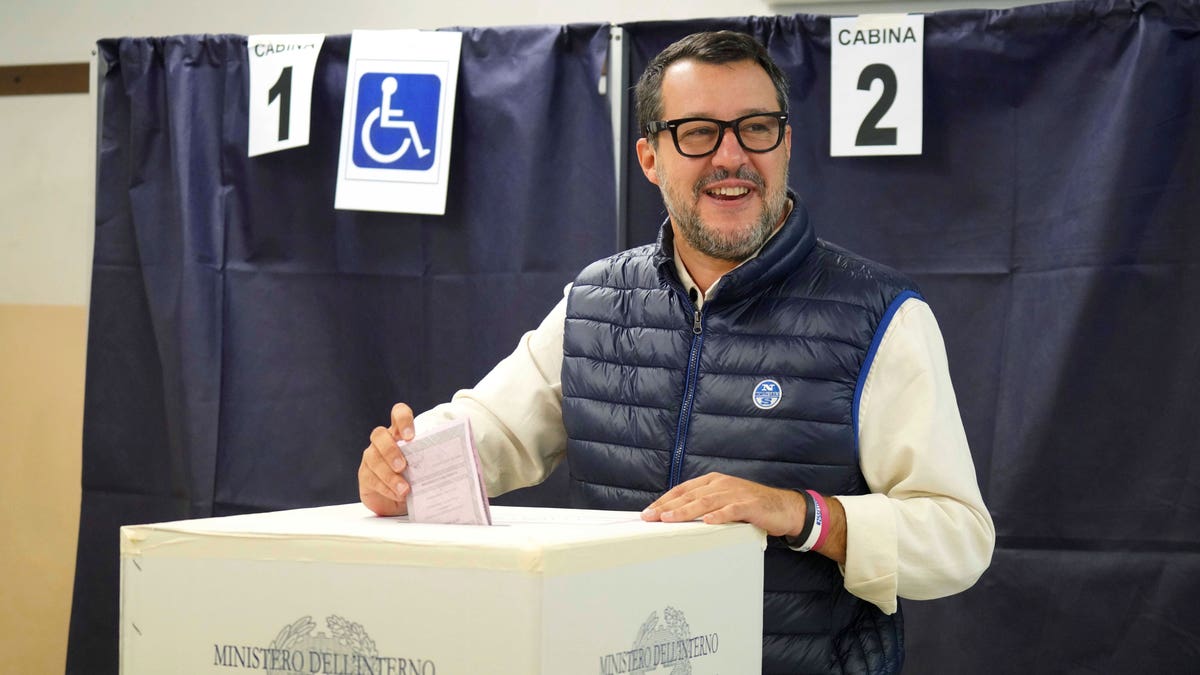 Man submitting his vote into a ballot box