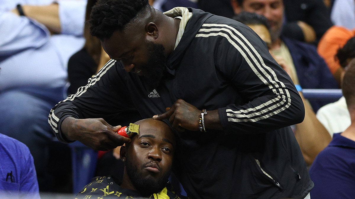 A fan was getting a haircut at the US Open