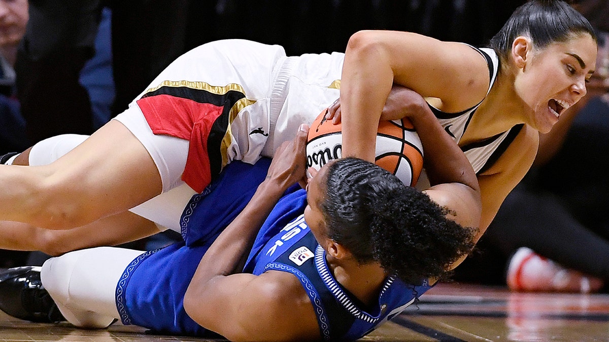 Kelsey Plum and Alyssa Thomas fight for the ball