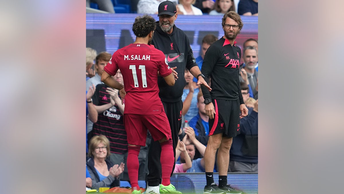 Mohamed Salah talks with Liverpool manager Jurgen Klopp.