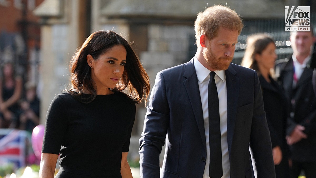 Downcast Meghan Markle in a black dress and Prince Harry in a black suit and black tie outside Windsor Castle after the Queen died