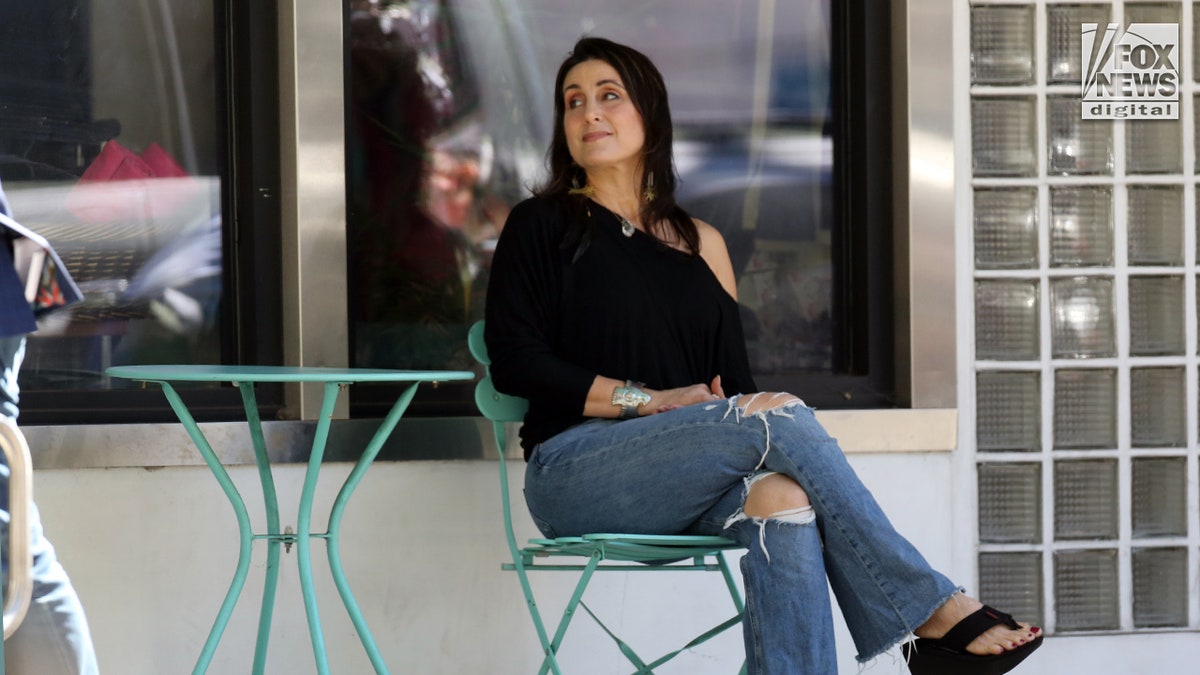 Alanna Zabel seated outside her yoga studio