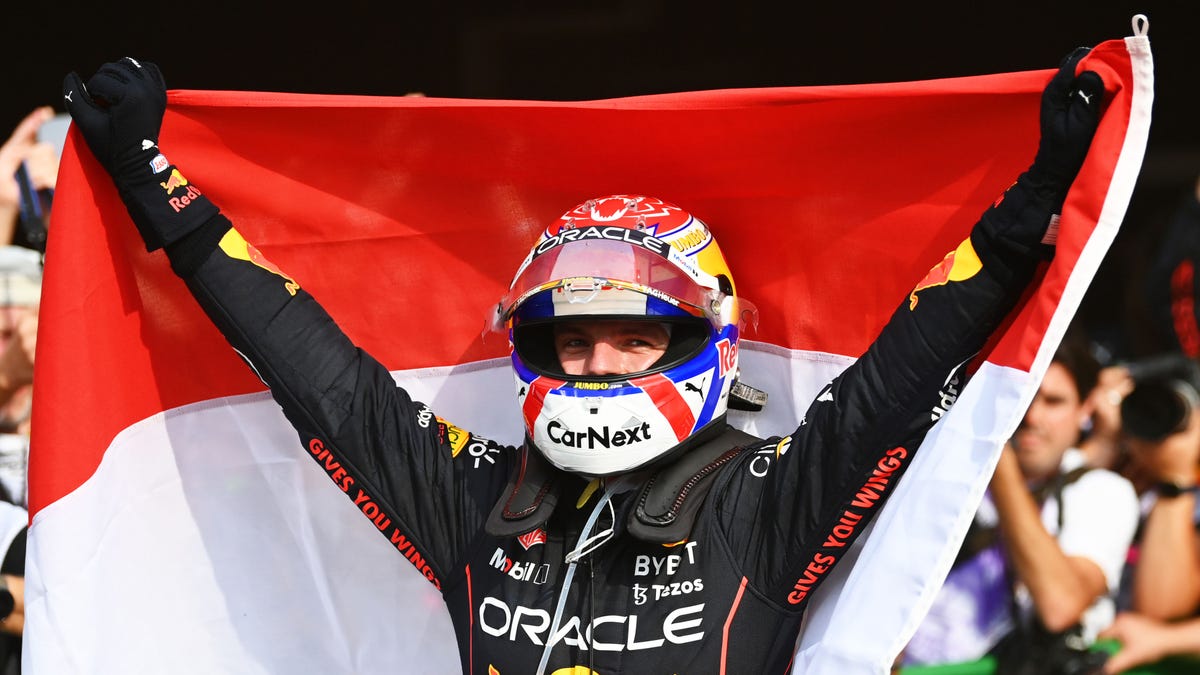 Max Verstappen holds flag