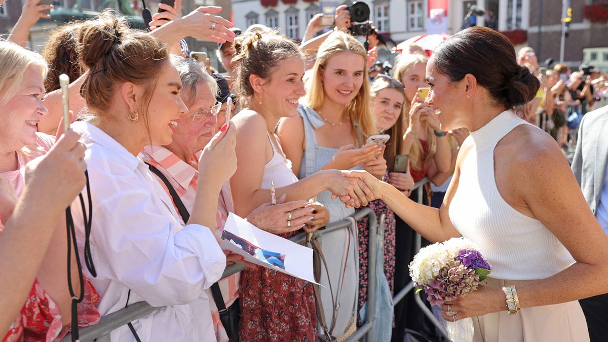 Meghan Markle speaks with fans