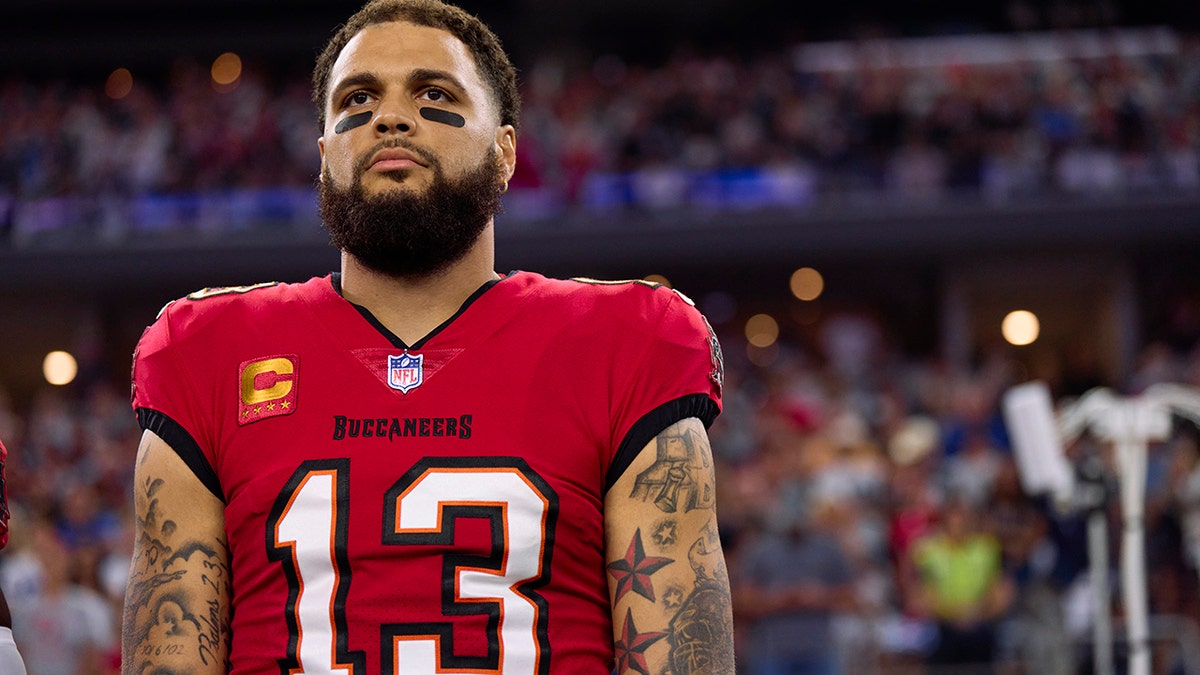 Mike Evans looks on before a game