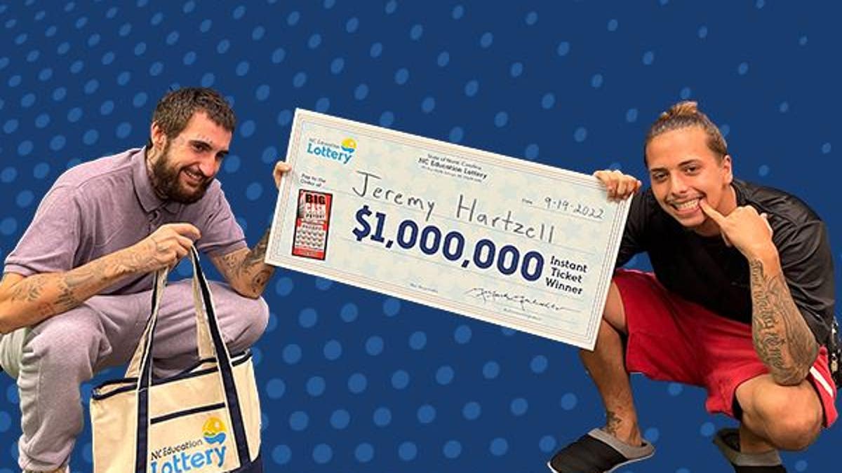 Two men posing with a million dollar check