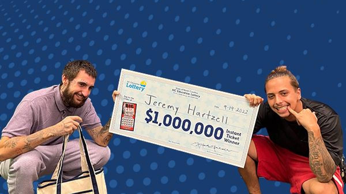 Two men posing with a million dollar check