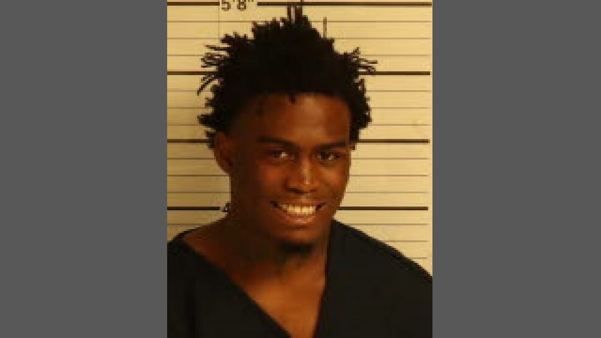 Ezekiel Kelly smiling in mug shot