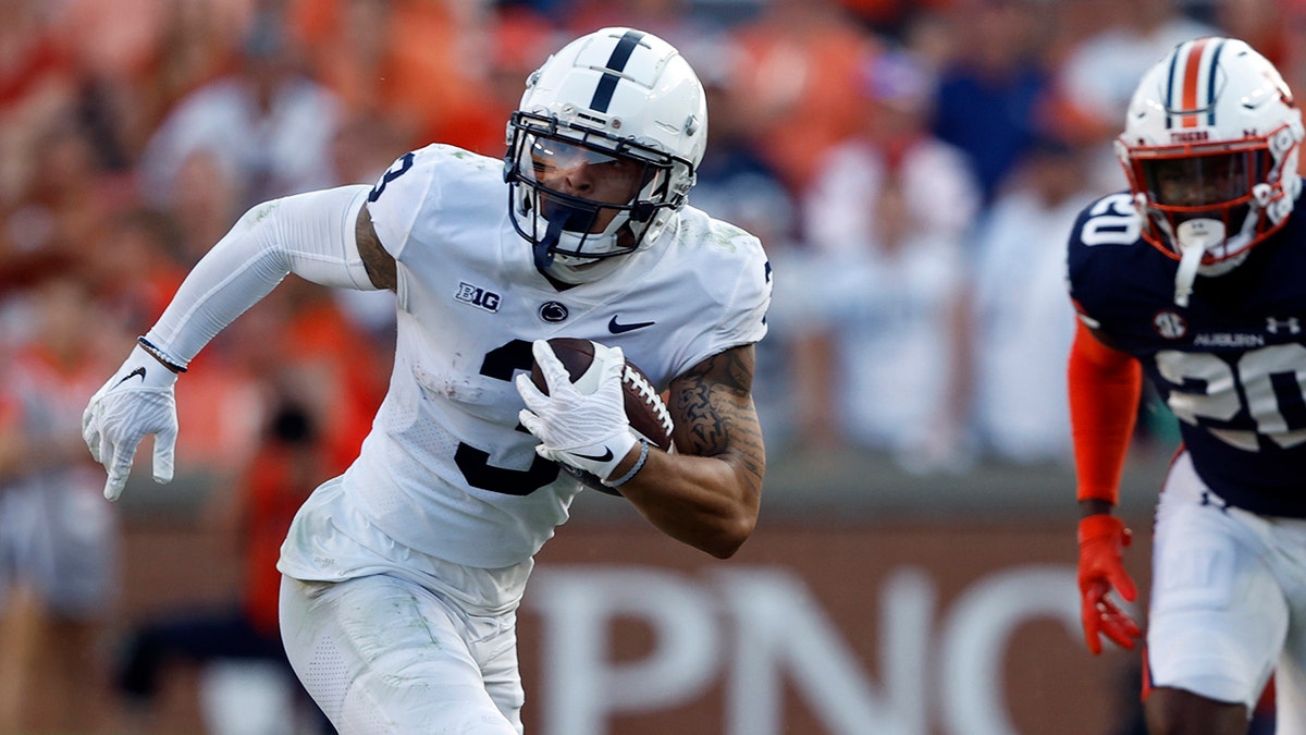Penn State's Parker Washington runs with the ball