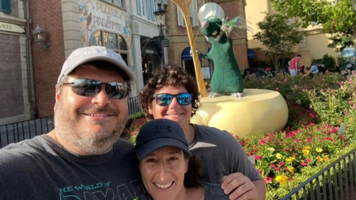 David Paventi in a t-shirt and ball cap with his family