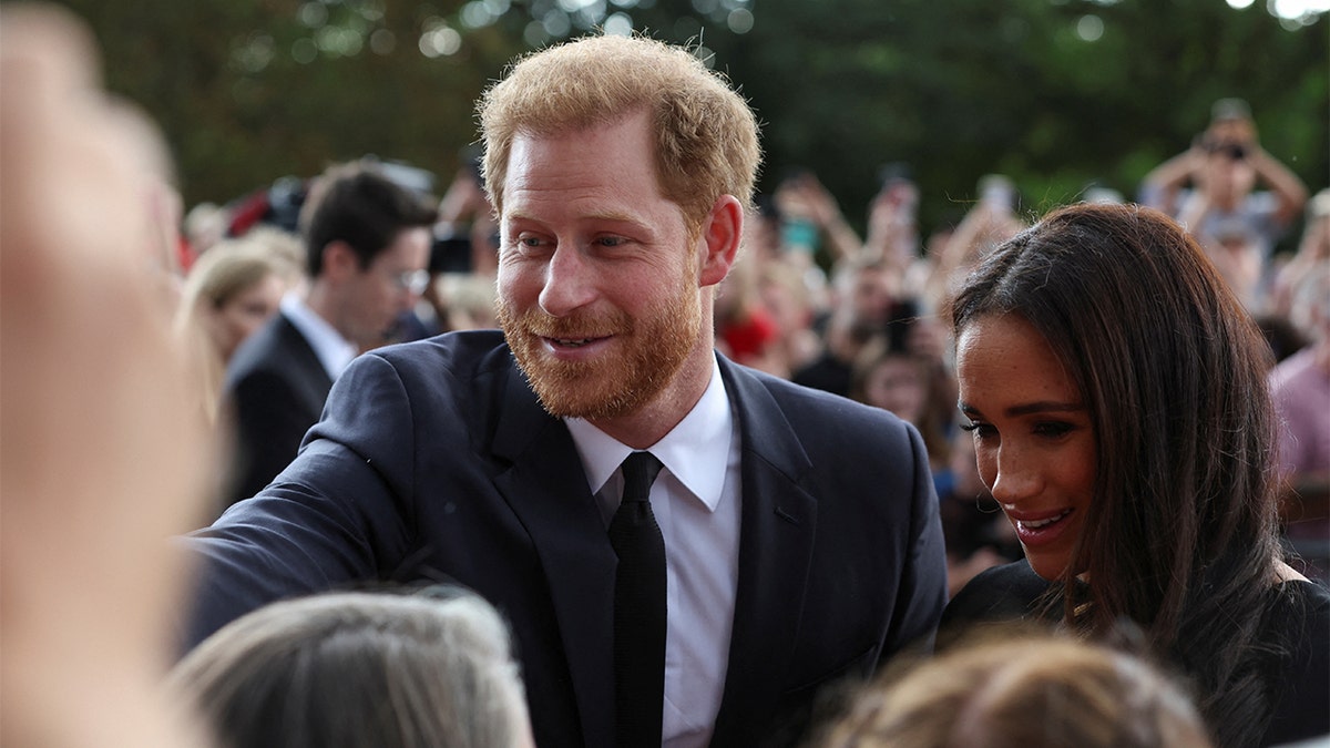 Prince Harry and Meghan, the Duchess of Sussex, greet crowds outside Windsor Castle after Queen Elizabeth's death