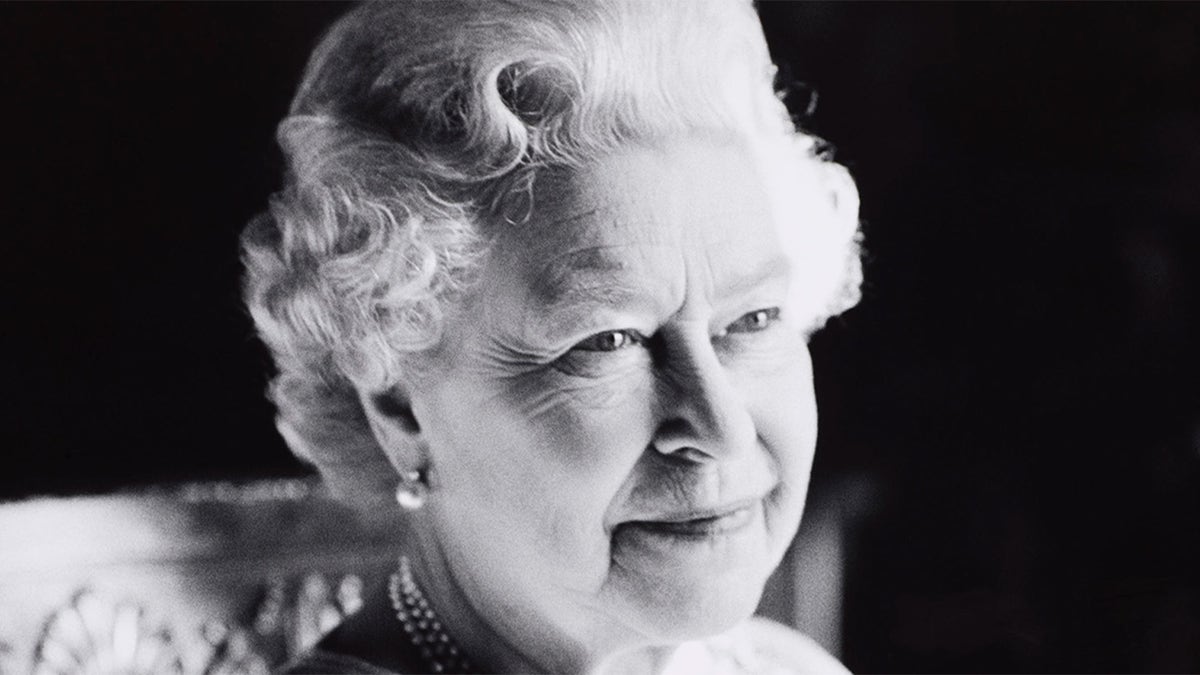 Queen Elizabeth II in black and white smiling