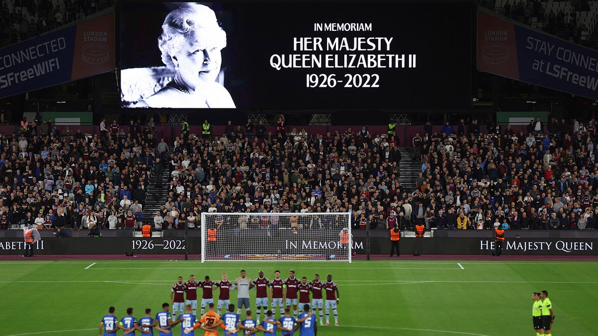 Team players stand on the pitch during minutes silence following the death of Queen Elizabeth II prior the Group B Europa Conference League soccer match between West Ham and FCSB Steaua Bucharest at London Stadium in London, Thursday, Sept. 8, 2022.