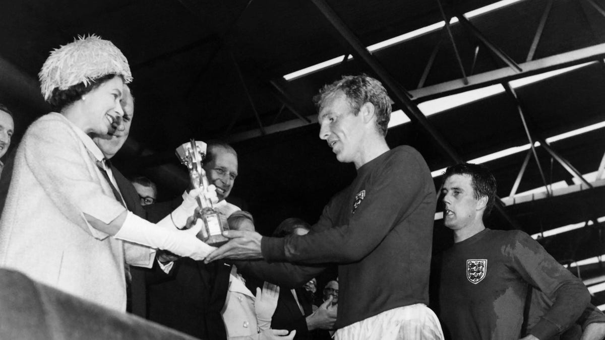 Queen Elizabeth II hands over trophy