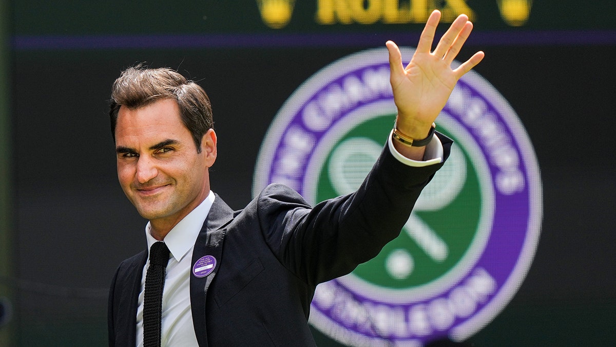 Roger Federer waves at Wimbledon