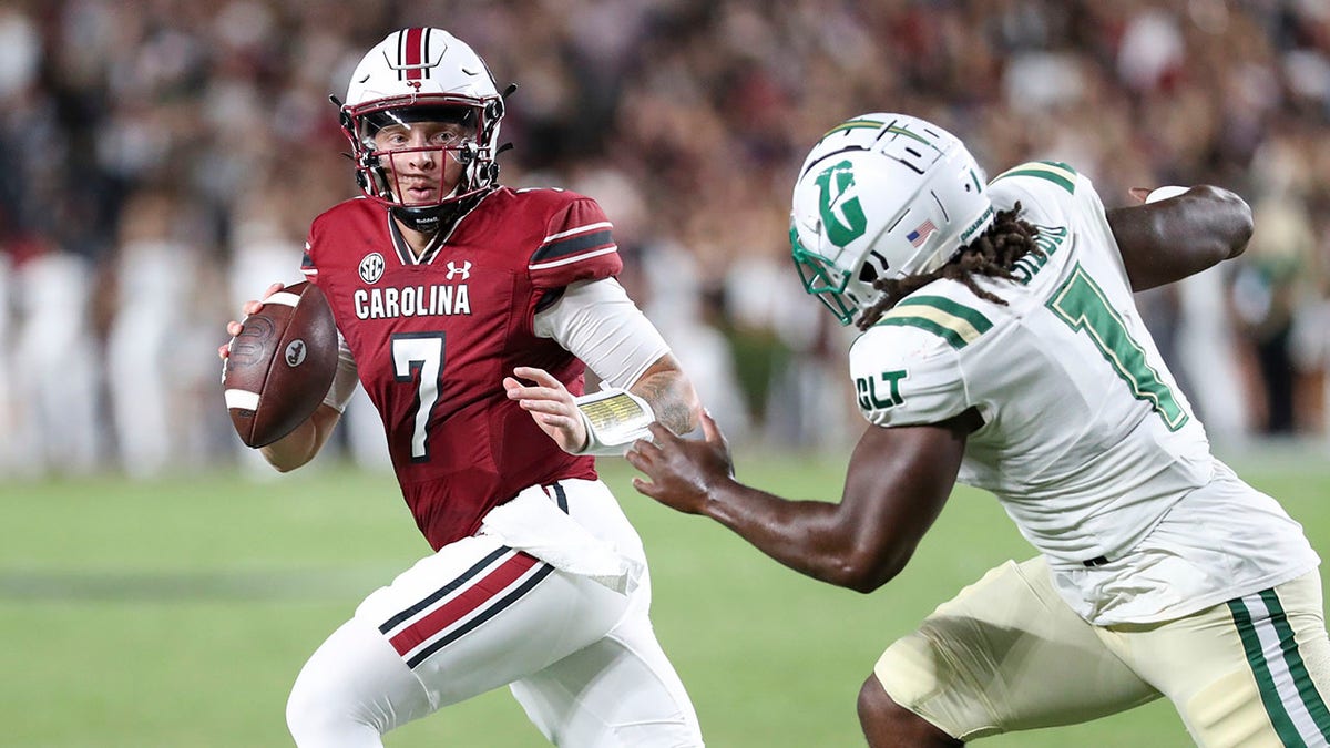 Spencer Rattler scrambles from defenders