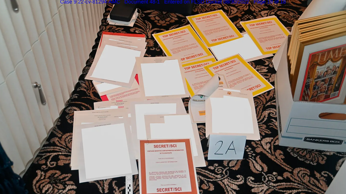 This image contained in a court filing by the Department of Justice on Aug. 30, 2022, and redacted in part by the FBI, shows a photo of documents seized during the Aug. 8 search by the FBI of former President Donald Trump's Mar-a-Lago estate in Florida. (Department of Justice via AP)